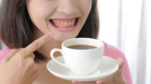 woman with teeth stains in a coffee