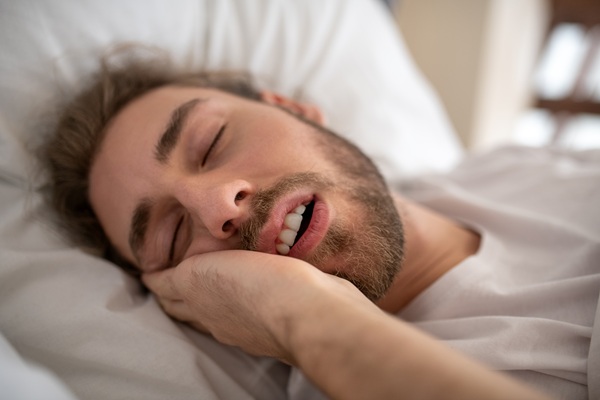 Good morning. A young man sleeping in his bed in the morning